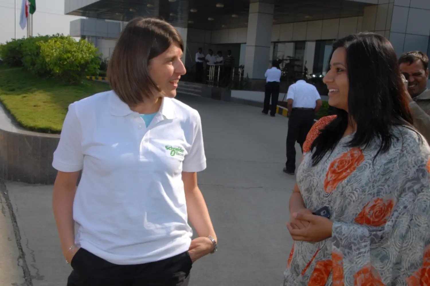 Man and woman speaking on stage at night with blue lighting